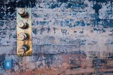 Brass standpipe ends set in rustic wall. Stock Photos