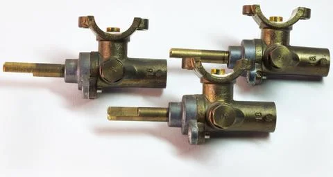 Brass surface burner valves from side. gas stove parts Stock Photos