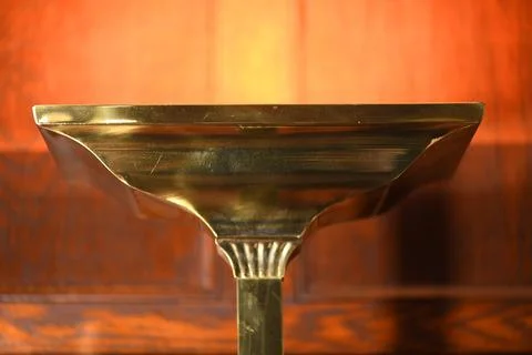 Brass torchiere lamp casts a glow on an 1899 wall Stock Photos