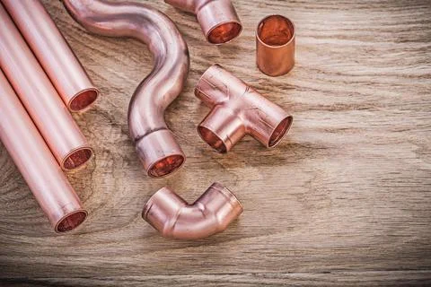Brass water pipe coupling tools on wooden board sanitary concept Stock Photos