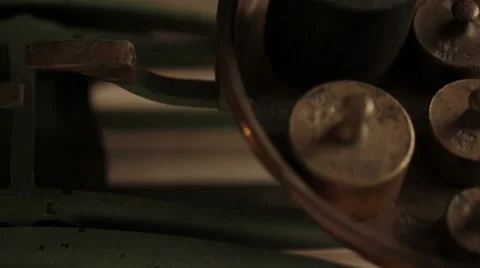 Brass weights added onto vintage mechanical scale - closeup Stock Footage 45985110