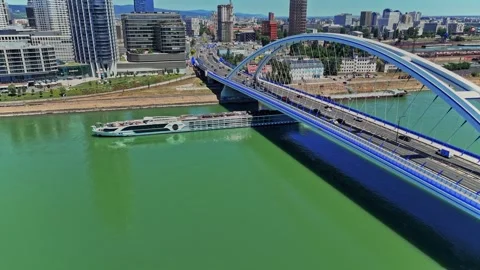 Bratislava view of a boat passing under a modern bridge on Danube River 스톡 동영상 337879037