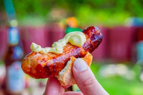 Bratwurst with mustard in a small bread roll Foto stock