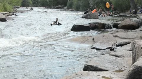 Brave boy flips over through a dangerous chute on a creek Video stock 11524547