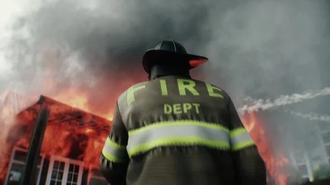 Brave Firefighter Approaching Burning House Surrounded by Flames. 库存影片 336515983