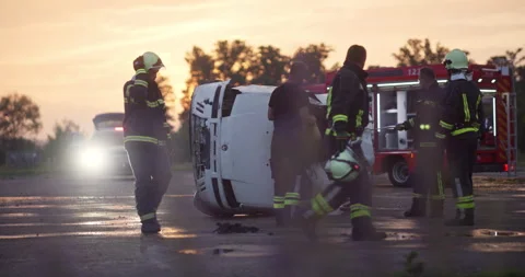 Brave Firefighters Team Walking to the Camera. In Background Paramedics and Video stock 247799394
