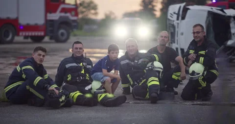 Brave Firefighters Team Walking to the Camera. In Background Paramedics and Video stock 248006357