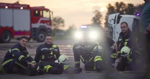 Brave Firefighters Team Walking to the Camera. In Background Paramedics and Video stock 248007211