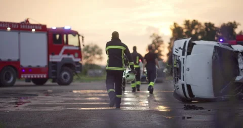 Brave Firefighters Team Walking to the Camera. In Background Paramedics and Video stock 253751731