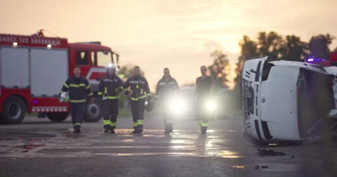 Brave Firefighters Team Walking to the Camera. In Background Paramedics and Video stock 253754632