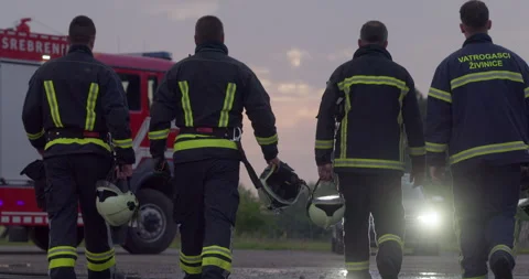 Brave Firefighters Team Walking to the Camera. In Background Paramedics and Video stock 253756605