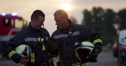 Brave Firefighters Team Walking to the Camera. In Background Paramedics and Video stock 283093532