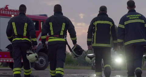 Brave Firefighters Team Walking to the Camera. In Background Paramedics and Stock Footage 283095068
