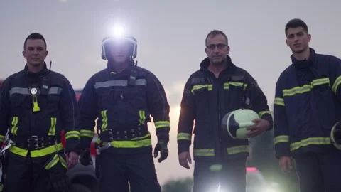 Brave Firefighters Team Walking to the Camera. In Background Paramedics and Stock Footage 305541787