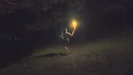 Brave Girl Traveling The Night Forest Holding A Fiery Torch In Hand. Slow Motion Stock Footage