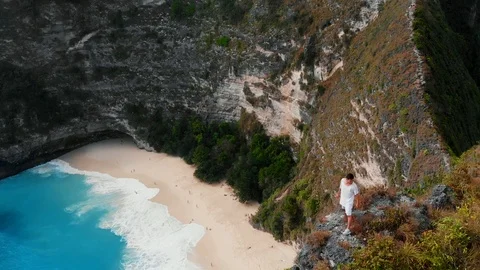 A brave guy stands on the edge of a cliff in Bali 2nd part Stock Footage 126142823