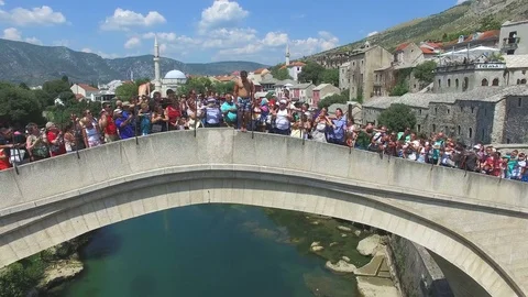 Brave man jumping of the bridge in Mostar, Bosnia and Herzegovina Stock Footage 72731560