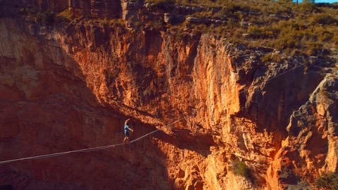 Brave Man Slacklining , highlining above a big canyon in Chulilla , Spain . Stock Footage