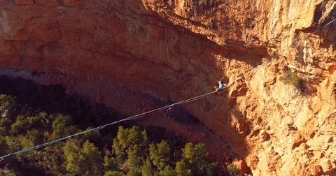 Brave Man Slacklining , highlining above a big canyon  Stock Footage 85267488