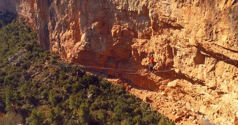 Brave Man Slacklining , highlining above a big canyon . aerial 4k Video stock 85269149