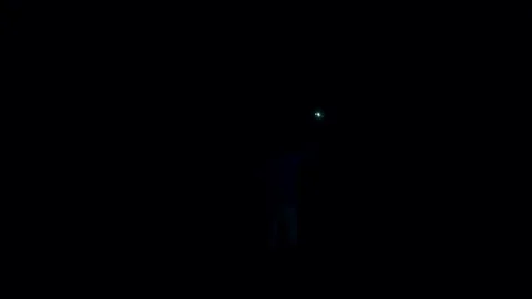 Brave man standing in the middle of explosion at night. Stock Footage 82222336