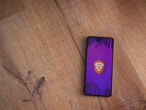 Brave Private Browser app launch screen on smartphone on wooden background Stock Photos