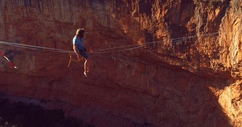 Brave young Man Slacklining , highlining above a big canyon. Stock Footage 85267650