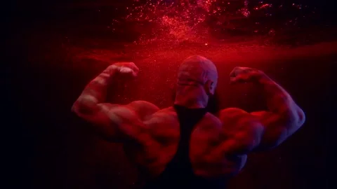Brawny bodybuilder is showing his muscular back and arms, floating underwater Stock-Footage 170640153