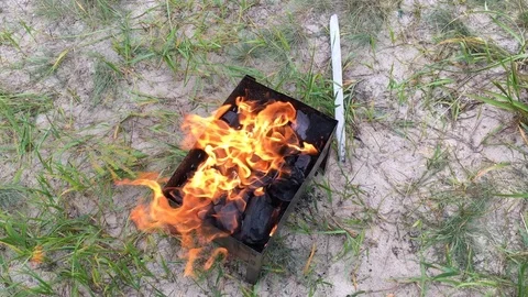 Brazier full of burning charcoal in preparation for an outdoor barbecue Stock Footage 89020936