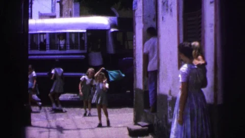 BRAZIL-1967: Elementary Children Getting Off Bus With Friends on City Street Stock Footage 124063983