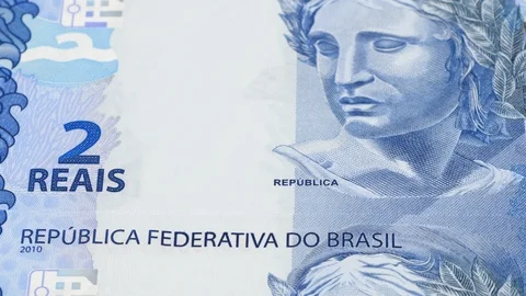 Brazil 2 real notes tracking. Slider shot. Low angle, macro. 4K Stock Footage 125402882