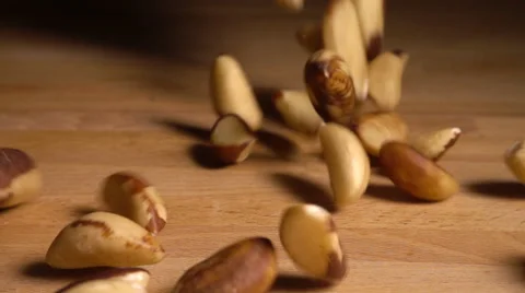 Brazil nuts fall onto table in slow motion Stock Footage 61691325