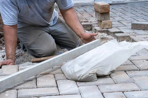 Brazilian and construction worker using a ruler to check the level of concr.. Stock Photos