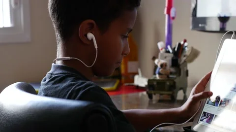 Brazilian boy using tablet computer at home Stock Footage 66575485