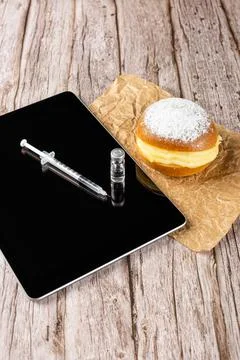 Brazilian cream doughnuts next to a syringe and ampoule with insulin and a ta Stock Illustration