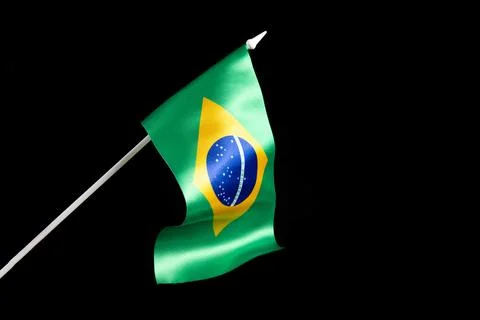 The Brazilian flag on a black background developing and fluttering in the wind Stock Photos