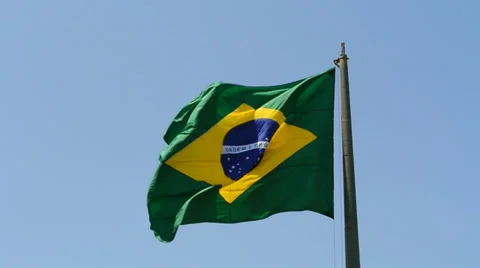 The Brazilian flag waving in the wind in front of blue sky Stock Footage 35044571
