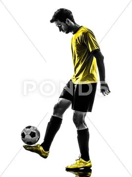 Brazilian soccer football player young man juggling silhouette Stock Photos