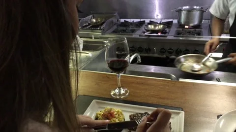 Brazilian woman eating a tuna with a industrial kitchen on background Stock Footage