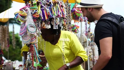 Brazilian woman showing her local products for the tourist in Salvador, Bahia Stock Footage