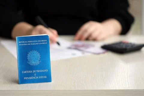 Brazilian work card and social security blue book lies on accountant or boss Stock Photos