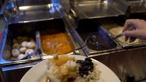 Brazillian cheese bread added to plate at buffet Stock Footage 126016630