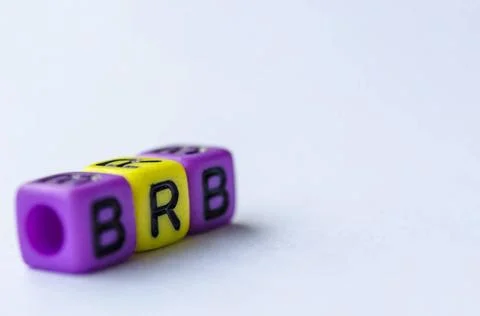 BRB text representing Be Right Back on small square toy on white backgroun... Stock Photos