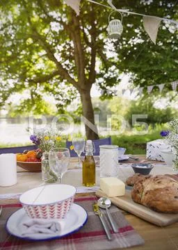 Bread and butter on patio table at lakeside Stock Photos
