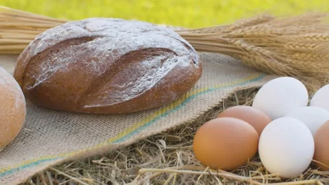 Bread and chicken eggs on fresh hay Stock Footage 139651081