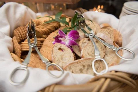Bread and cracker basket with serving tongs Stock Photos
