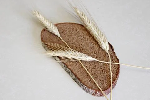 Bread and ear on a white background Stock Photos