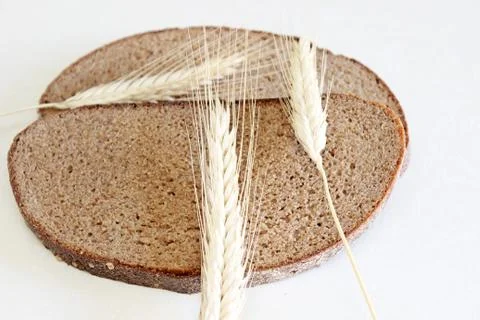 Bread and ear on a white background Stock Photos
