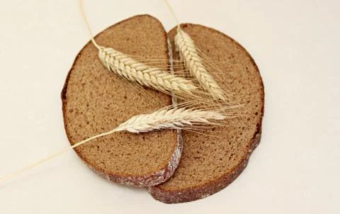 Bread and ear on a white background Stock Photos