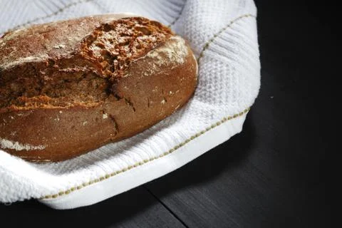 Bread and fabric on black table Stock Photos
